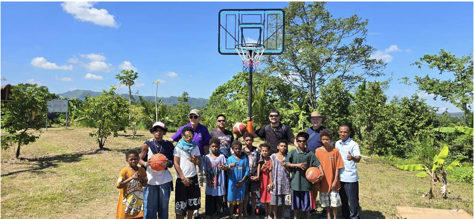 Community members gathered around the basketball hoop